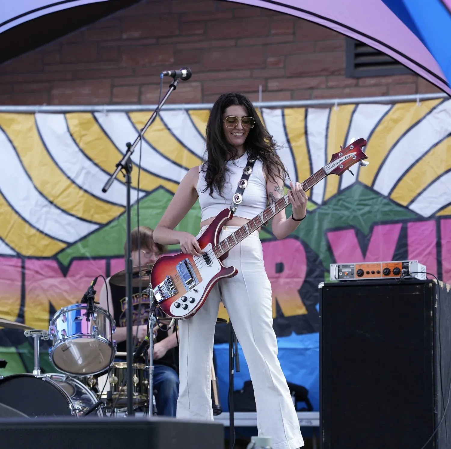 Guitarist on stage in front of the Summer Vibes backdrop